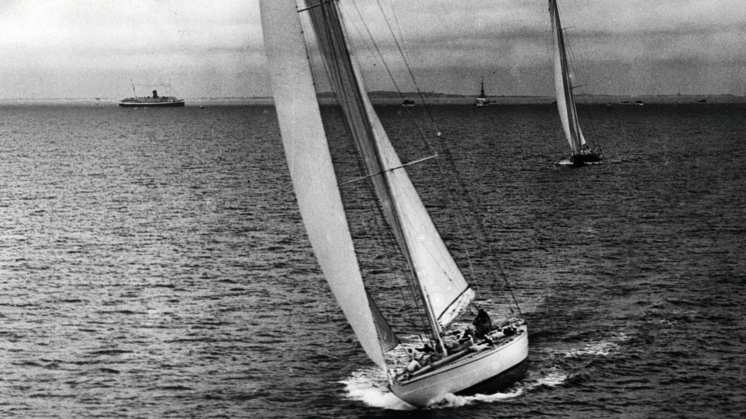 Black and white photo of Endeavour and Rainbow on the water