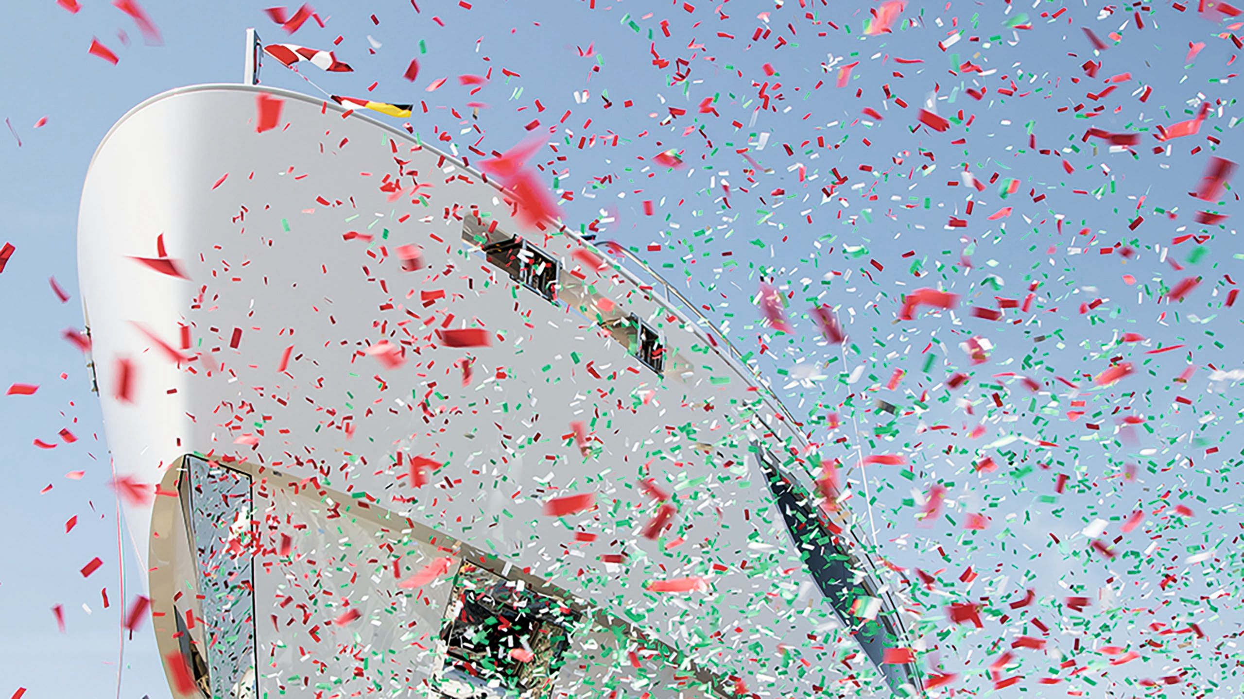 Front view of Maverick with pink, white and green confetti fluttering in the foreground