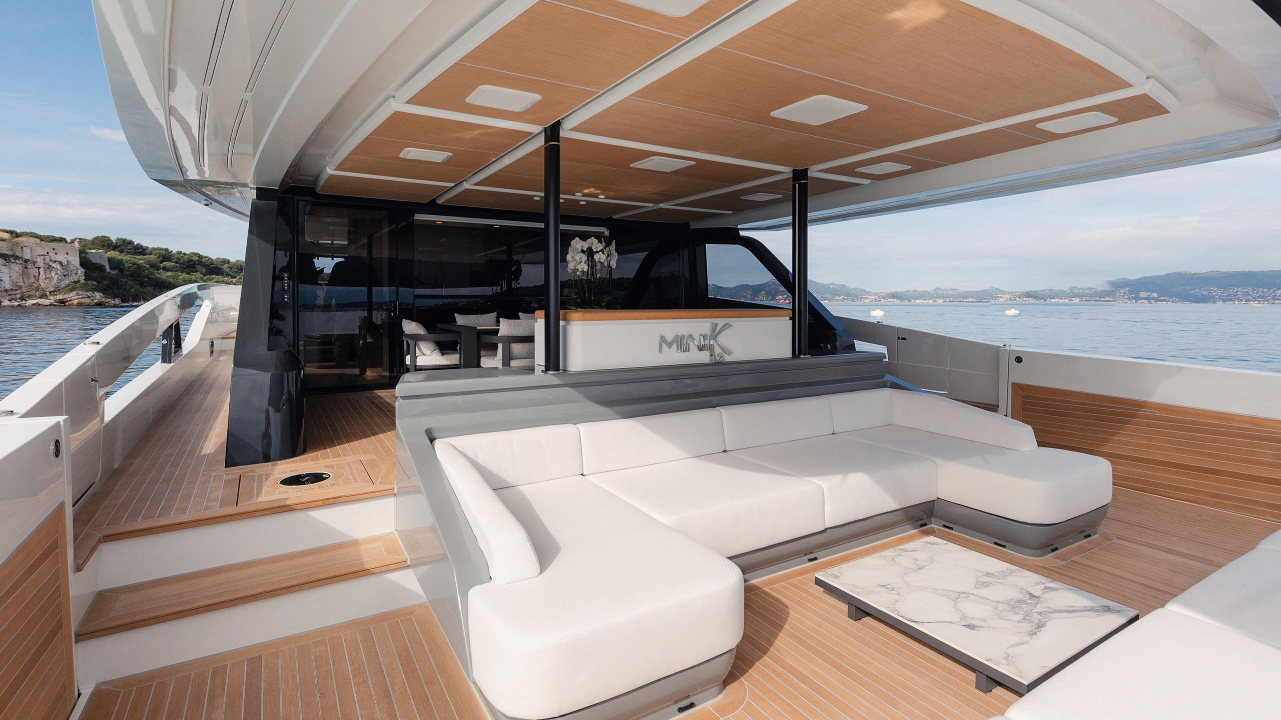Alternative view of the u-shaped white sofa on the aft deck