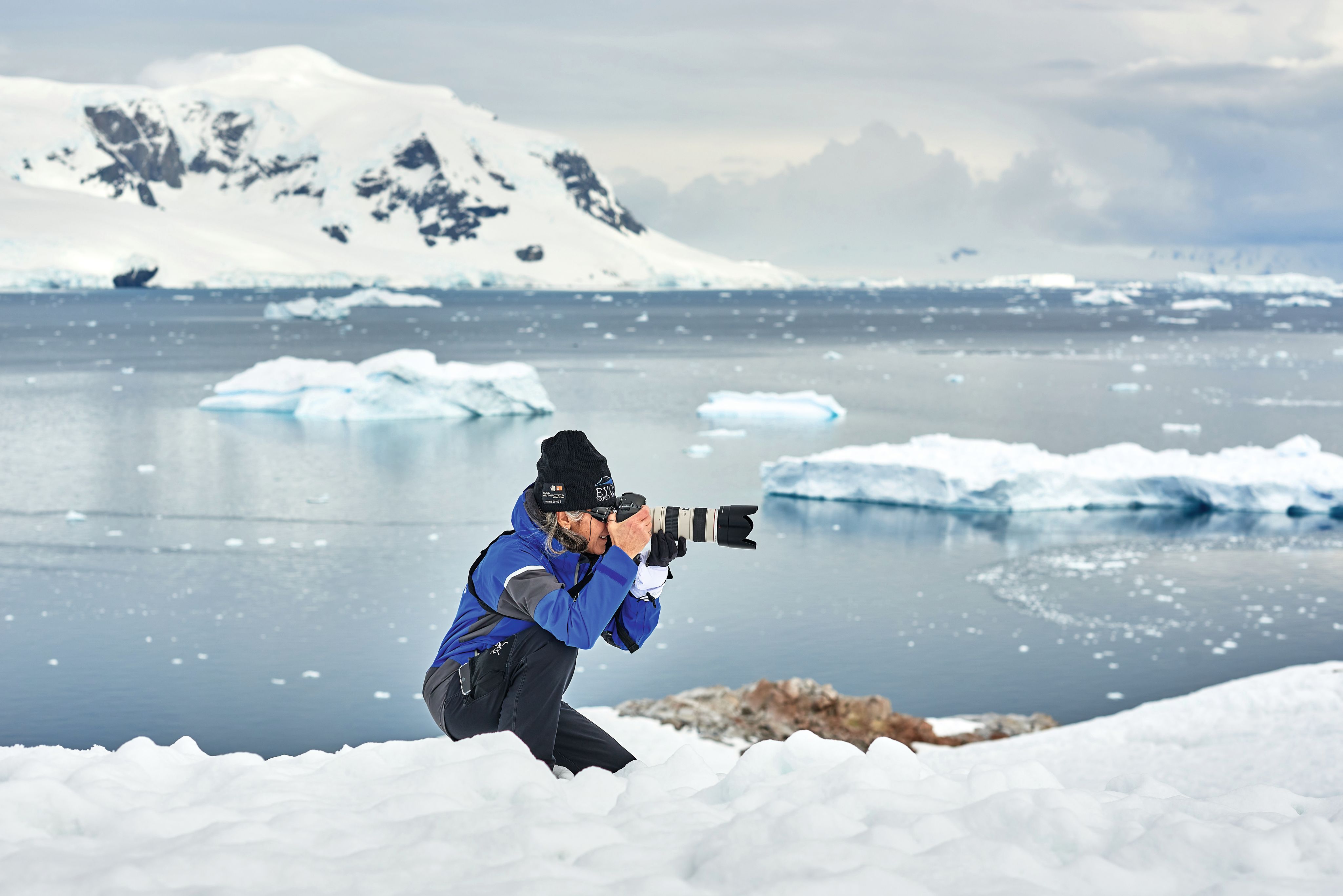 Man photographing glacial landscape