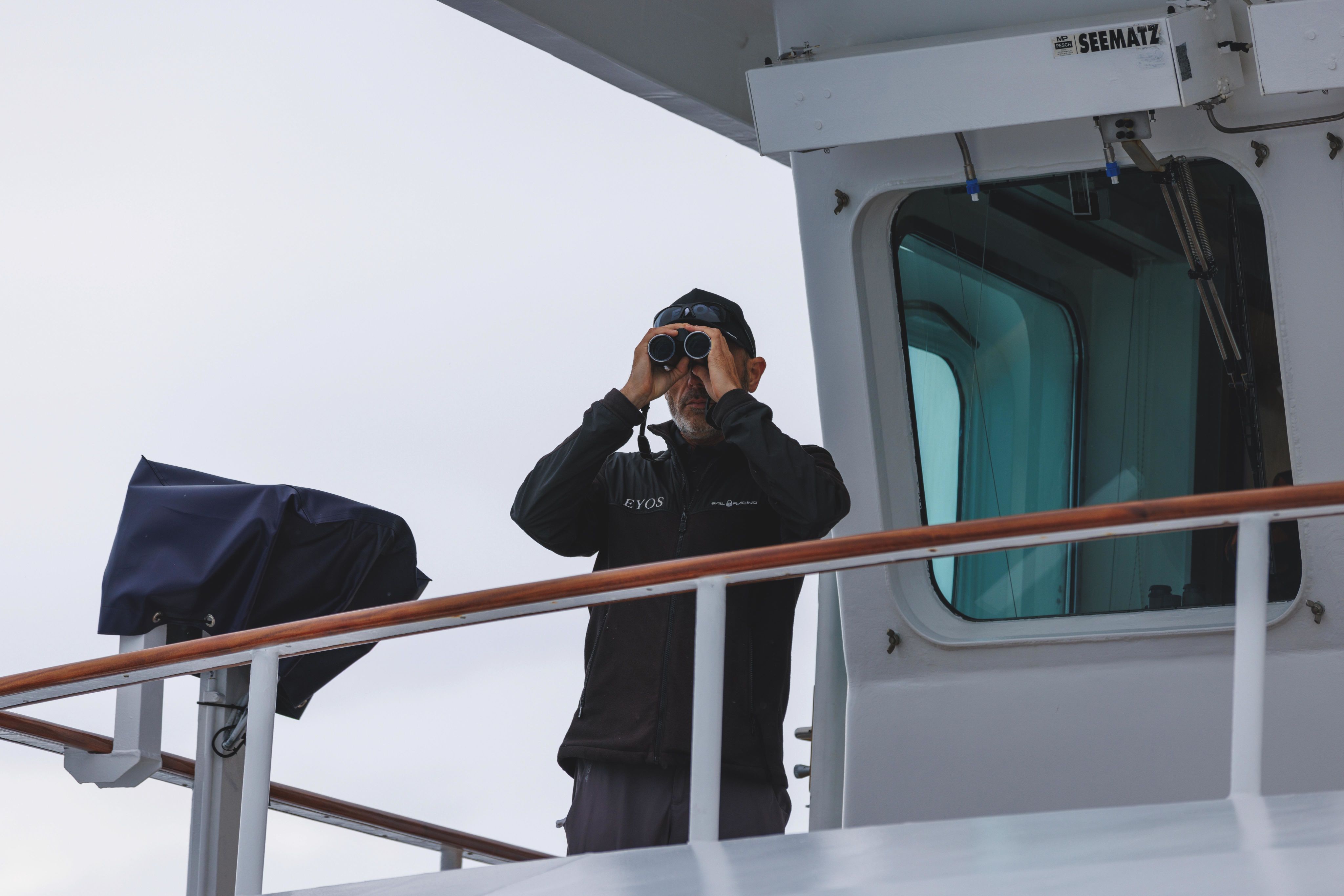 Richard White looking through binoculars