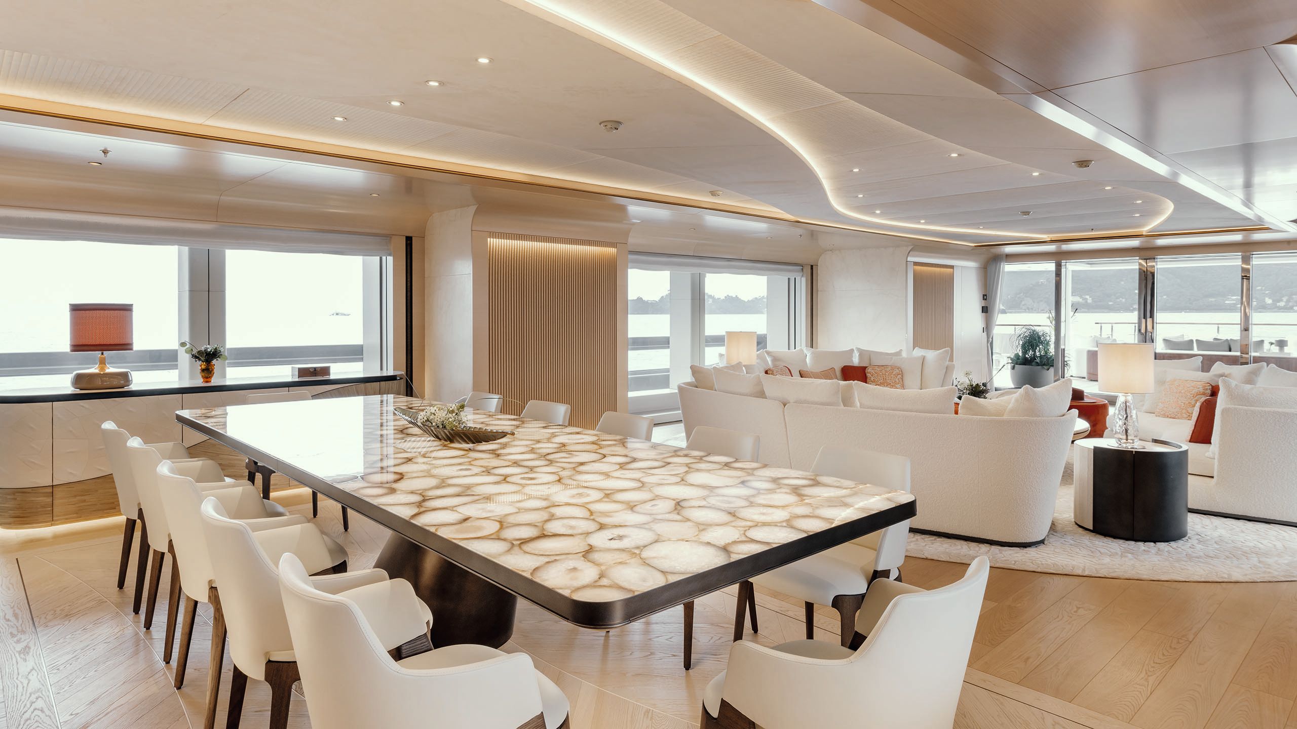 Side view of agate table with five chairs either side