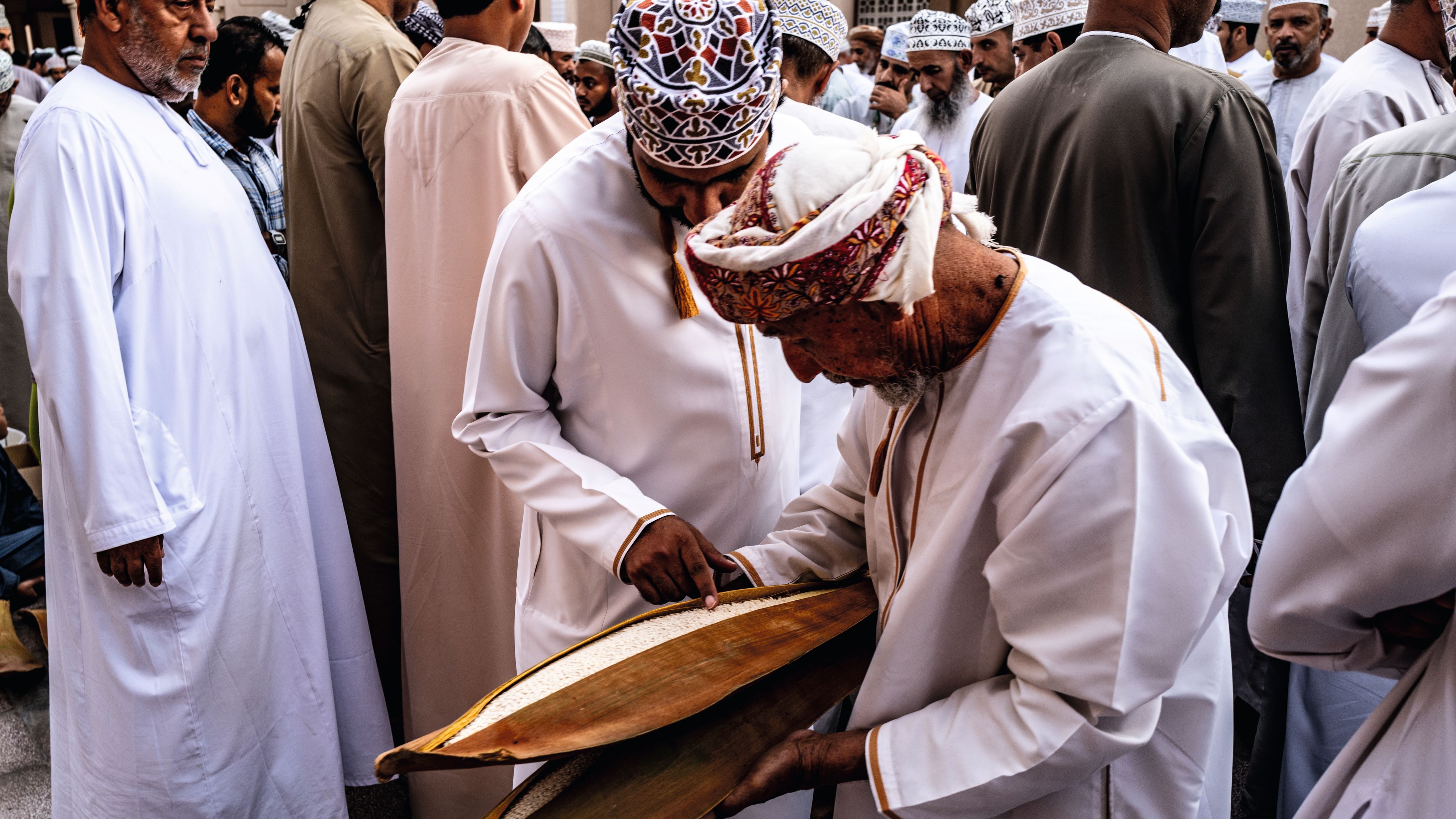 Men at the market examining the date palm stamen