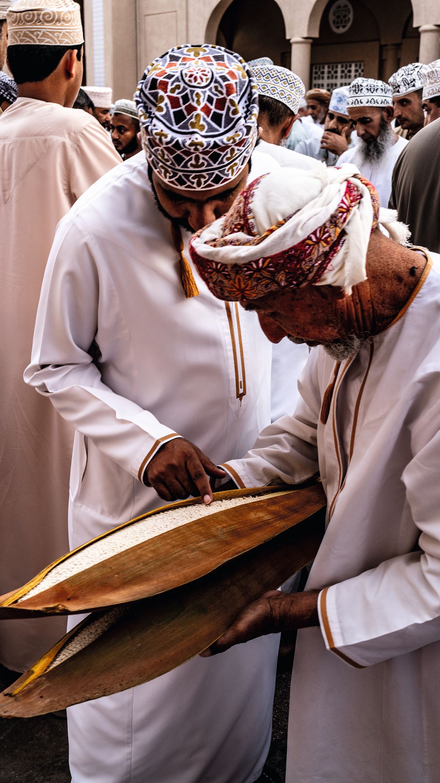 Men at the market examining the date palm stamen