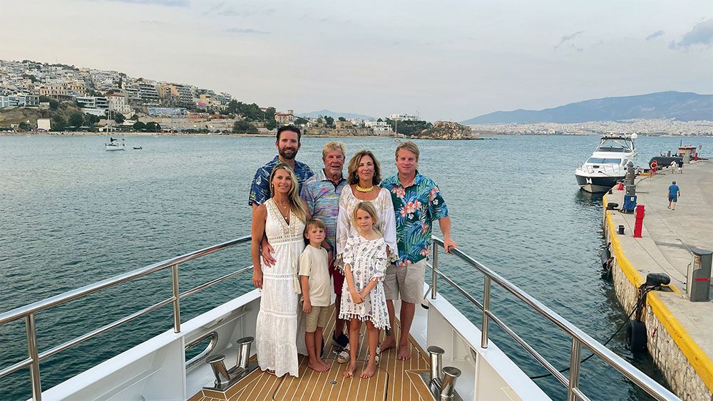 A family photo of the Minieas taken with them standing on the nose of the boat