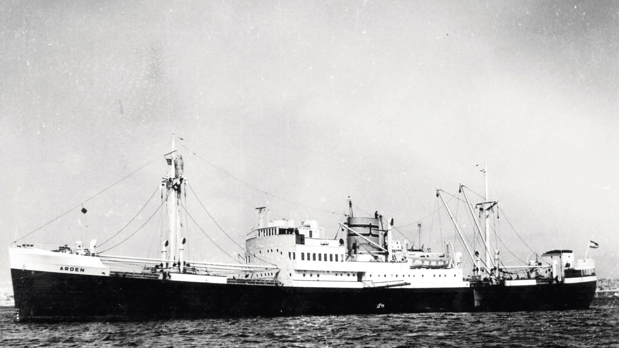 A black and white photo, taken from the side, of the large M/V Arden