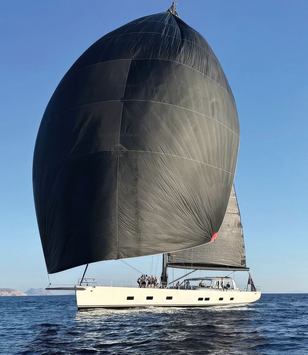 Wally B from the side. It has two large black sails