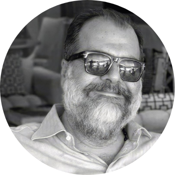 Black and white head and shoulders shot of Pateras