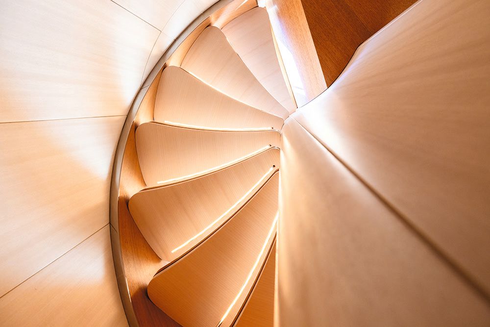 Overhead view of the spiral staircase, which is lit from underneath