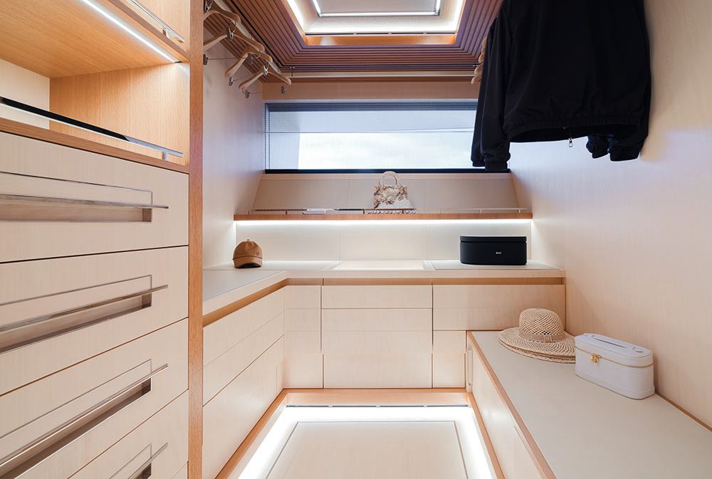 Interior of the wardrobe, which has cream drawers and chrome detailing
