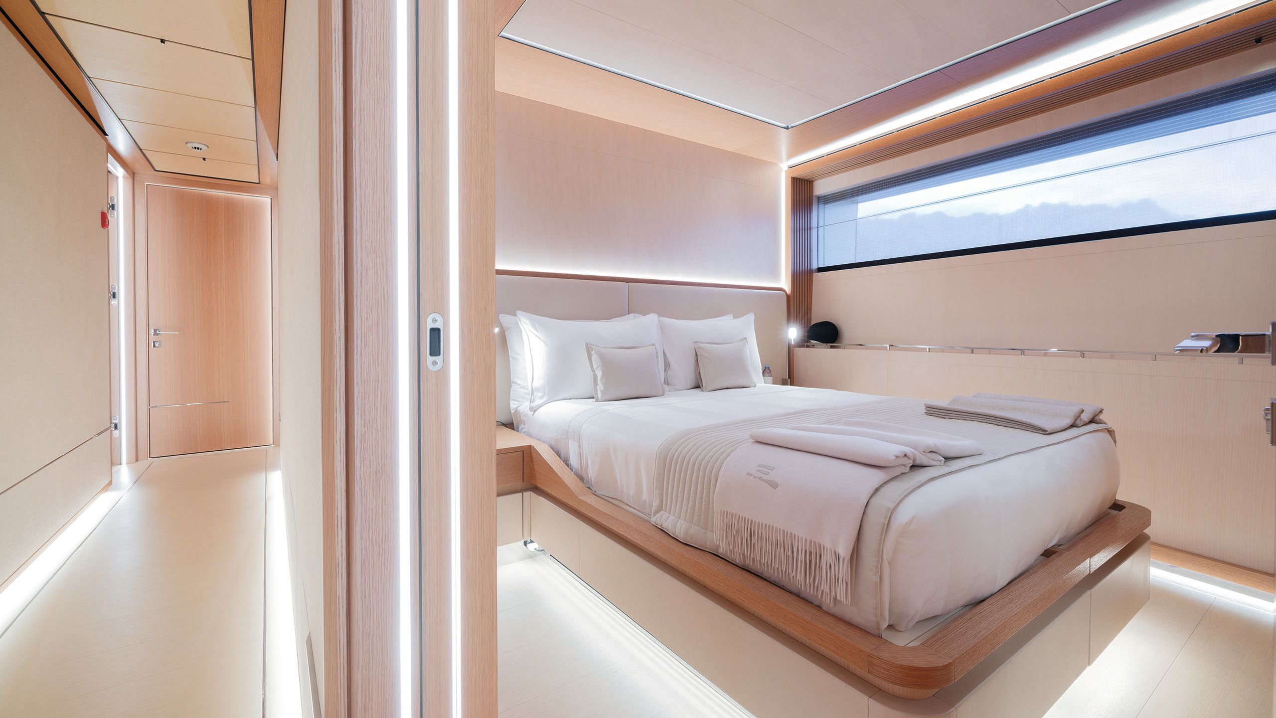 View looking into the guest/crew area. The beds are made up with neutral linens