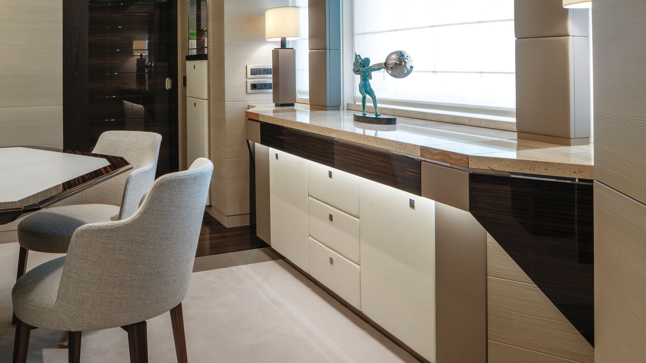 Close-up of the statuette, which is blue and the globe, which is silver