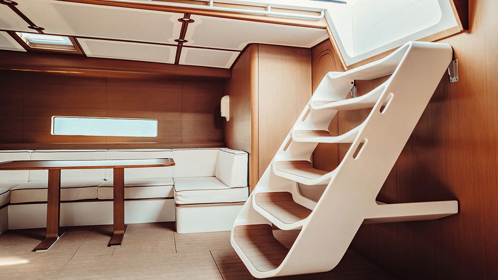 A white staircase on the right leading down into the boat