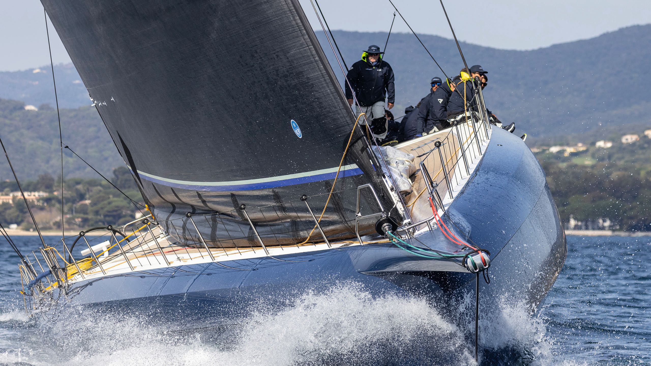 Front view of Magic Carpet E on the water with its sails up