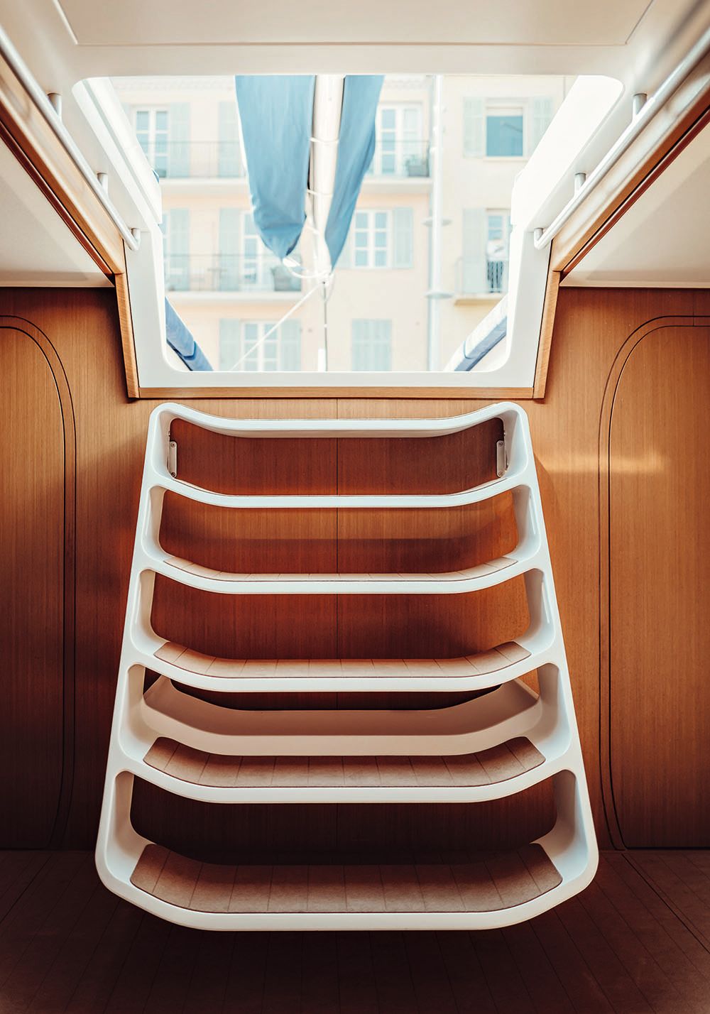 Front of white stairs leading down into the boat