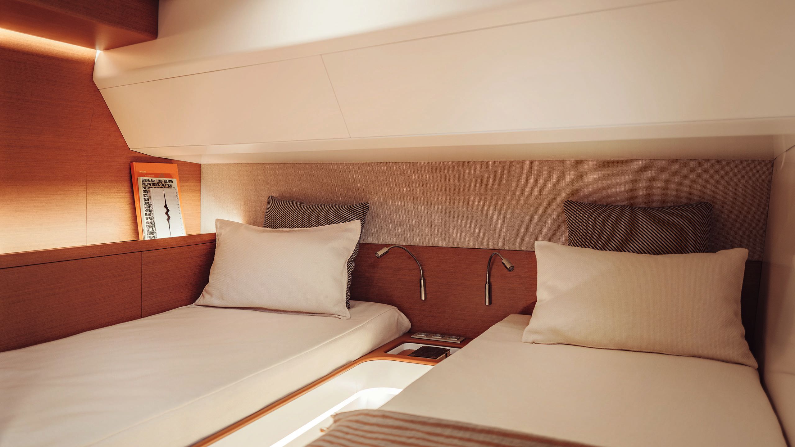 Twin beds in a guest cabin with cream linens