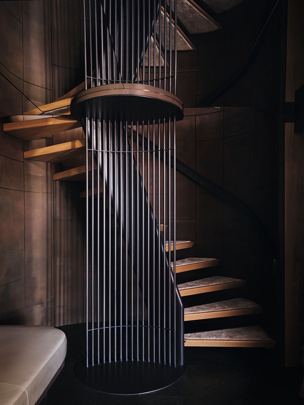 Spiral staircase wrapped around a sculpture of metal rods
