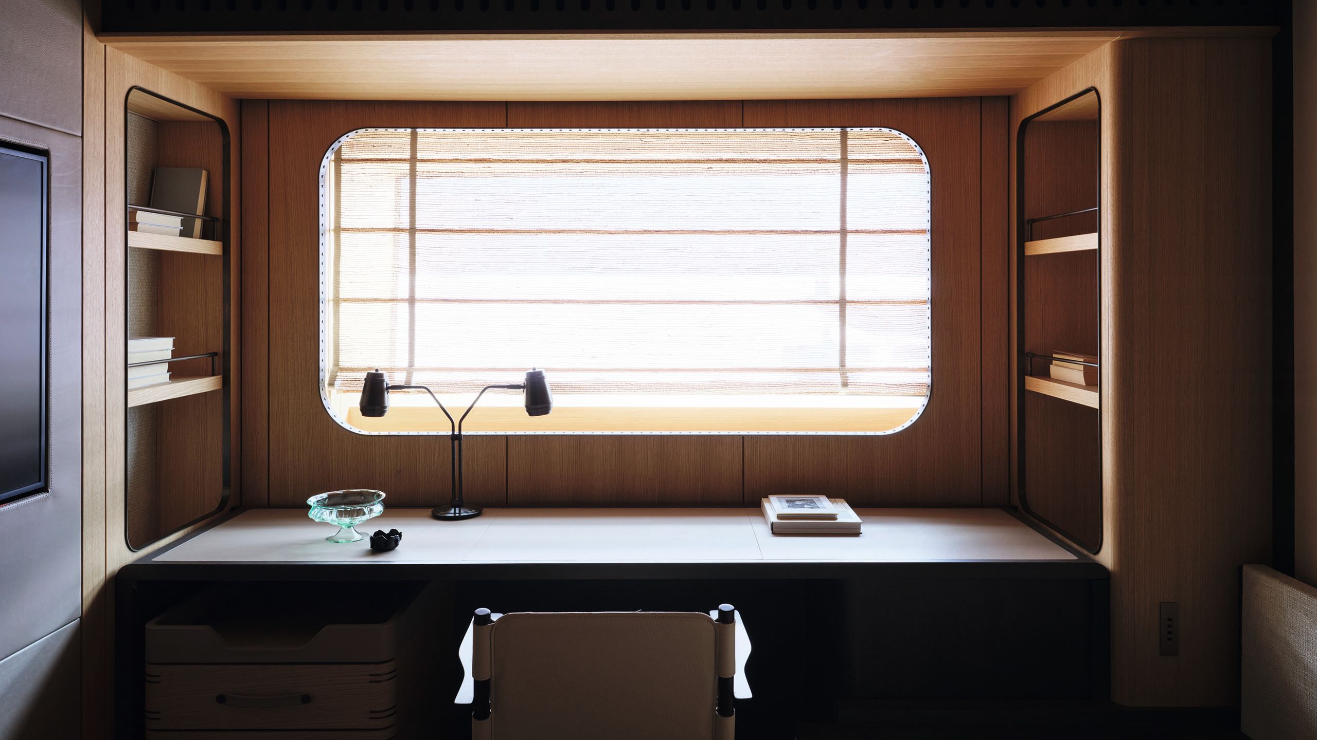 The VIP cabin has a desk under a rectangular window