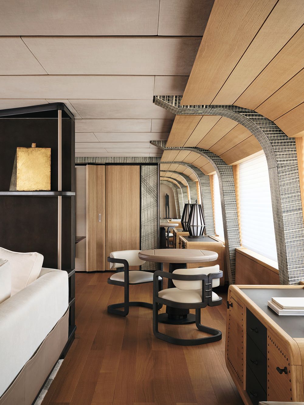 Beige round table with two chairs in dark wood with cream cushions