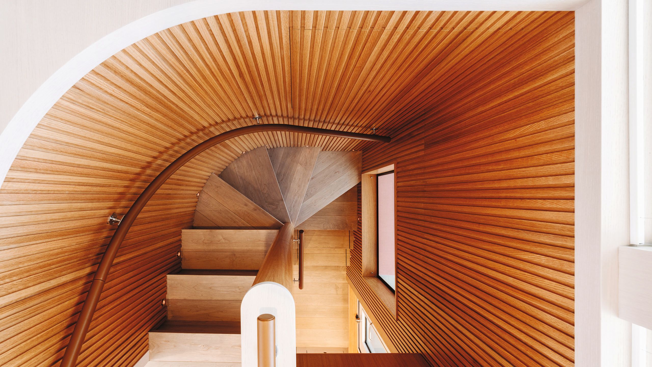 Aerial view of spiral staircase with ribbed sides and whitewashed oak treads