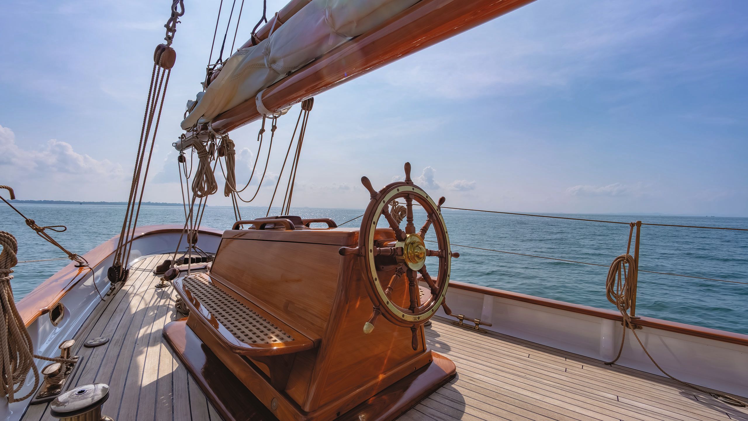 Wooden steering wheel on the deck