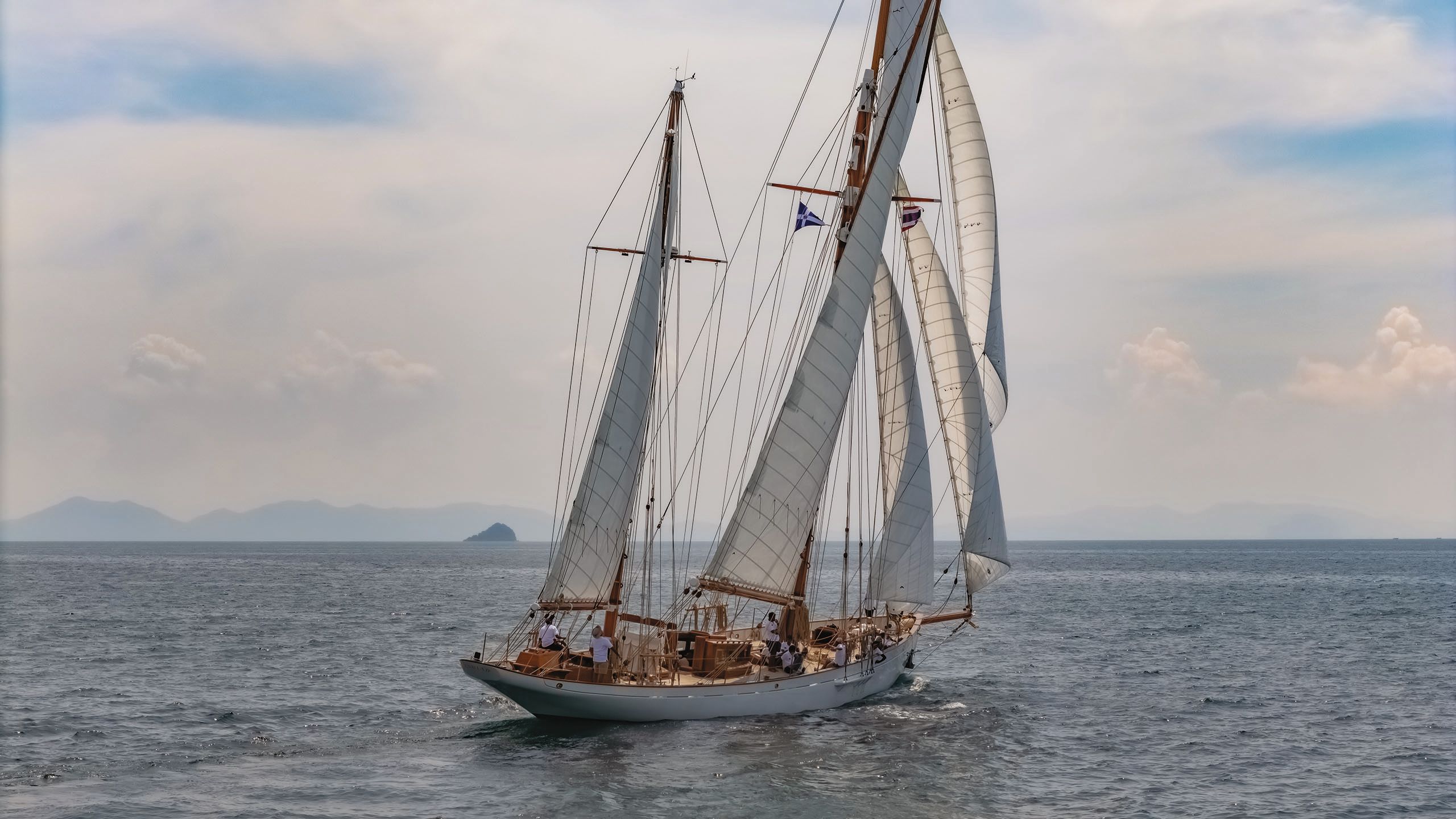 Cariad from the side with its sails out on the water