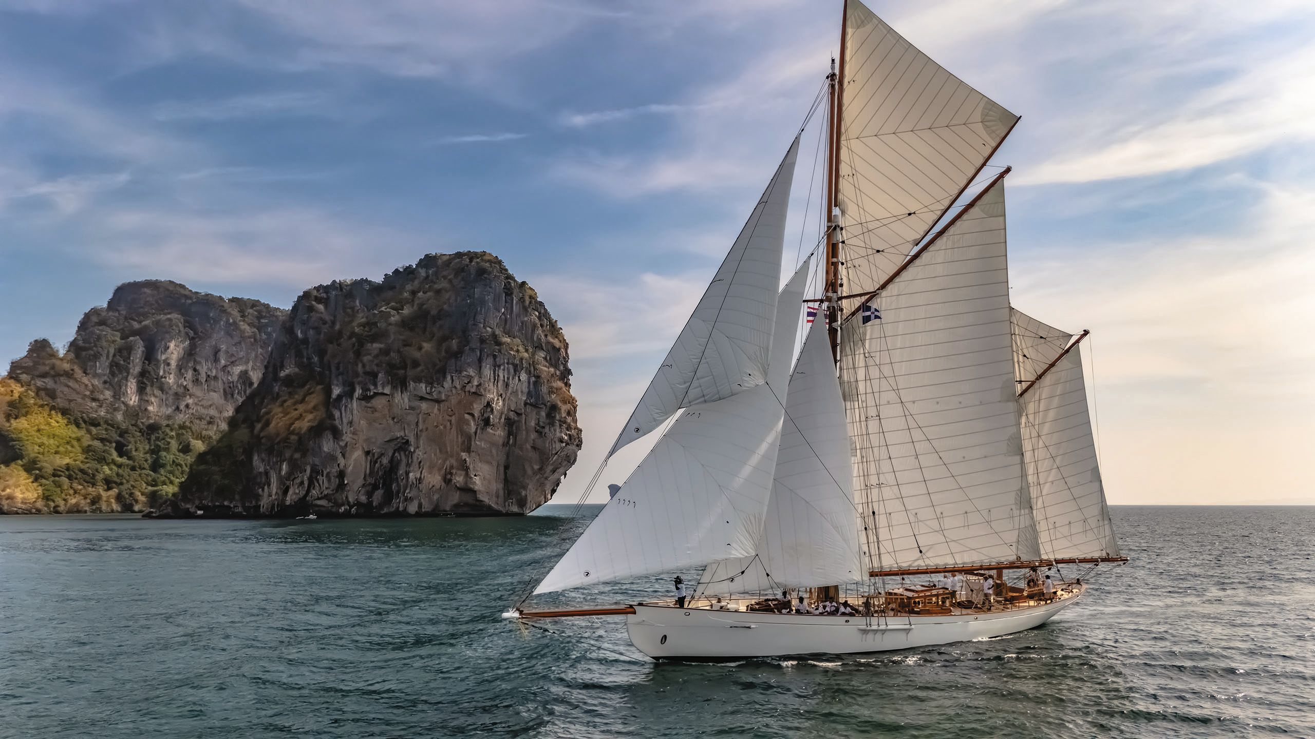 Cariad from the side with its sails out on the water