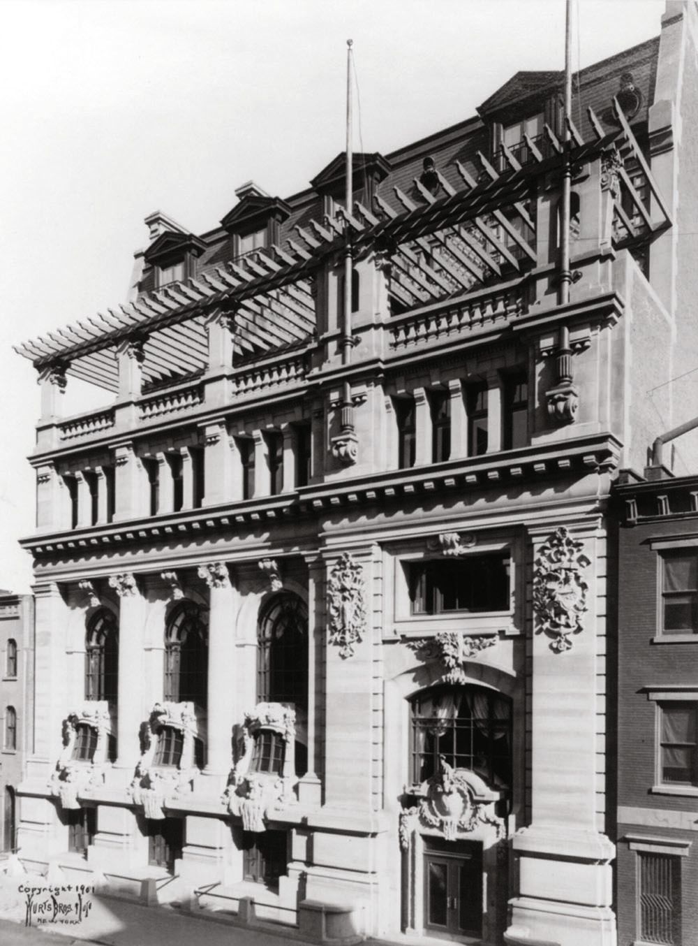 Black and white photo of an old building in New York with intricate details on the brickwork