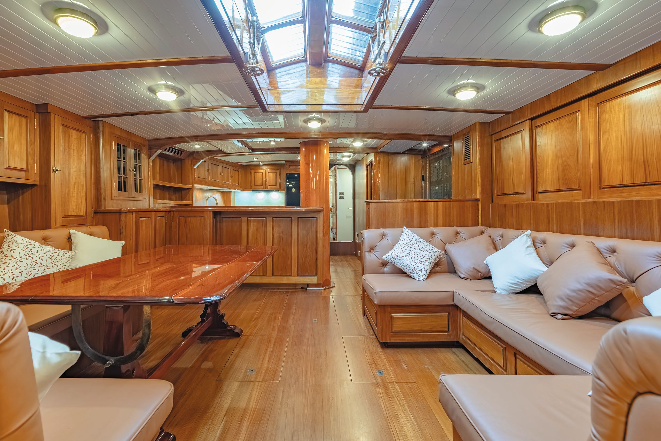 Inside the main salloon deck - everything is done in an orange-tone wood and there is leather banquette seating in tan