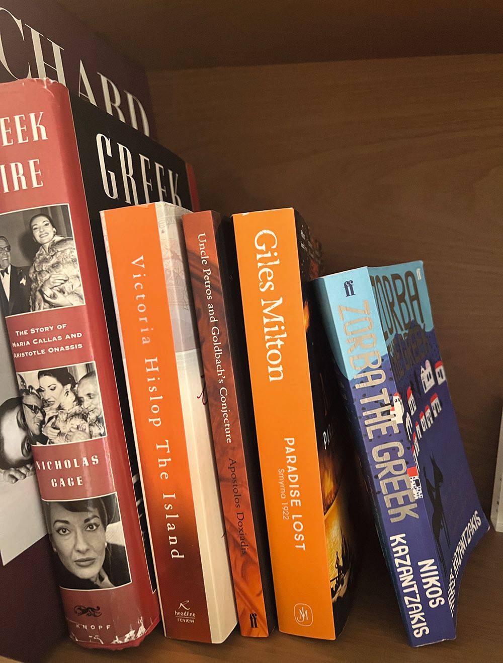 Selection of books on a shelf, including Paradise Lost and The Island