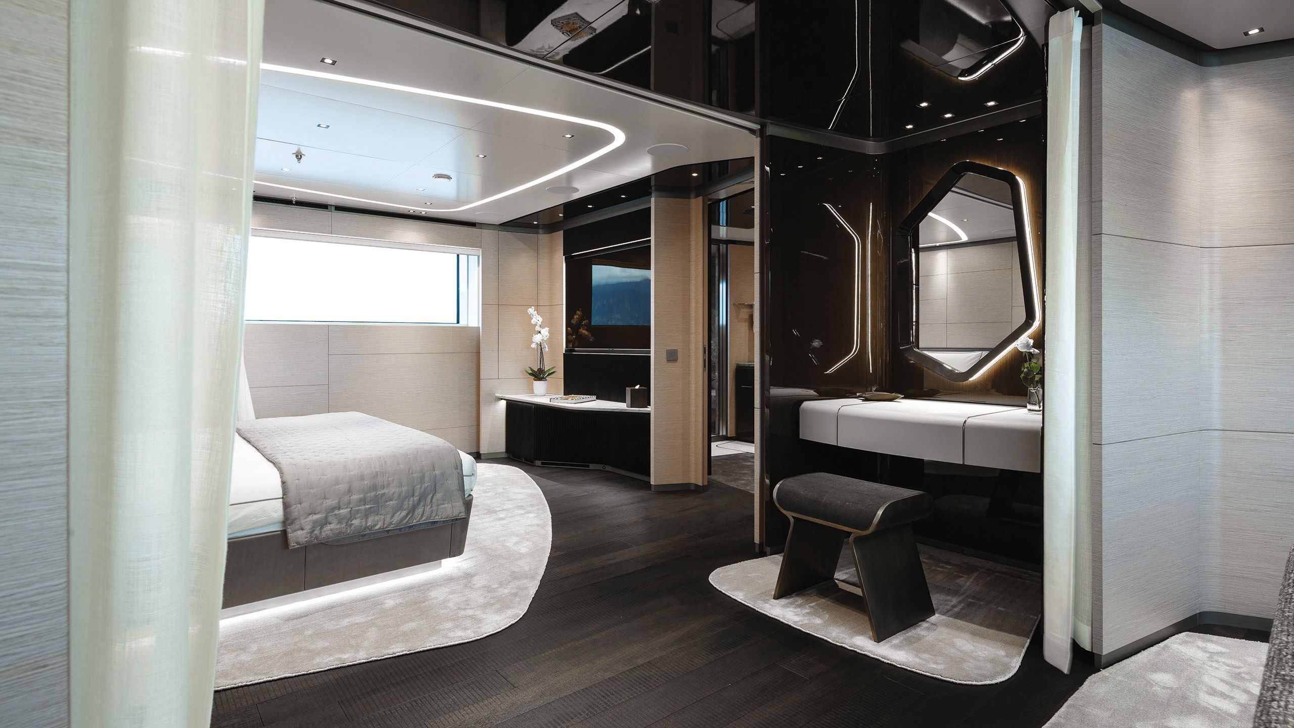 A guest cabin with neutral linens/rugs on the bed and on the floor, which is dark wood