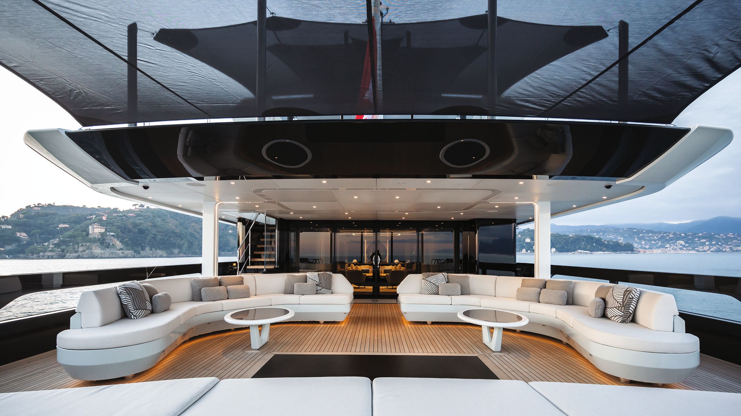 Curved white sofas on a covered deck area