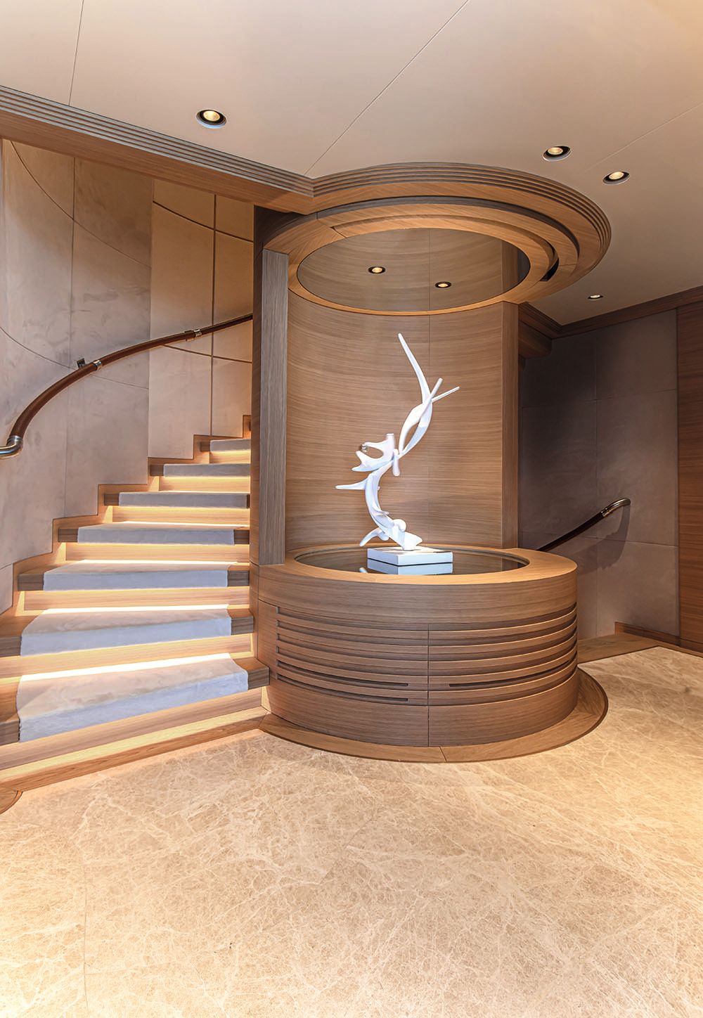 White abstract sculpture at the foot of the spiral staircase