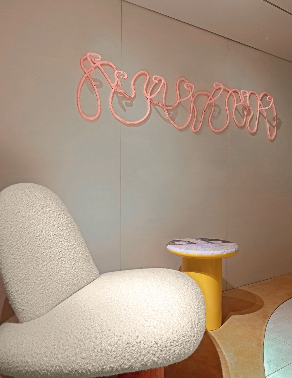 An abstract wall hanging made of peach rope