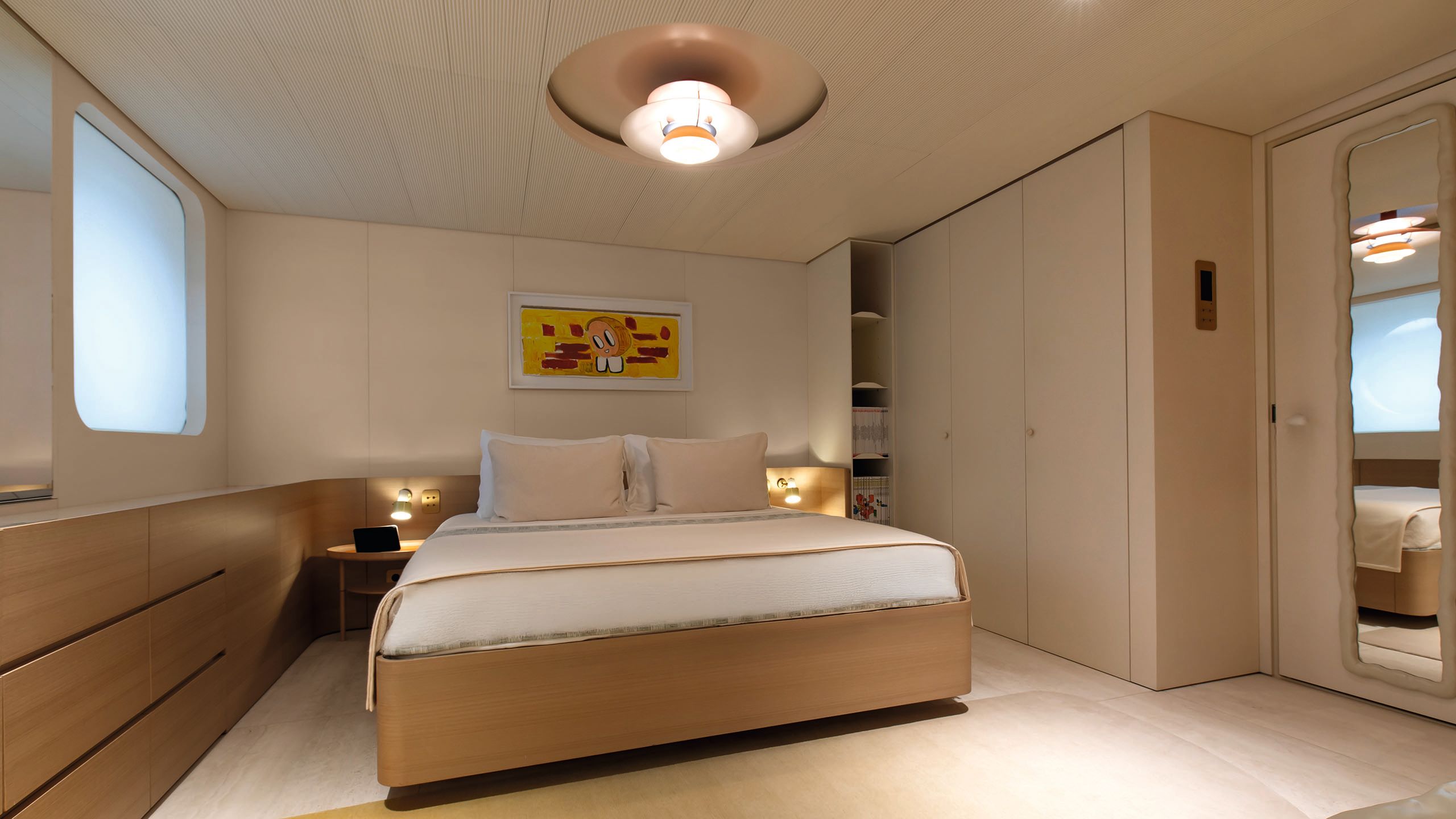 Face on view of a guest bed, which is made up with neutral linens