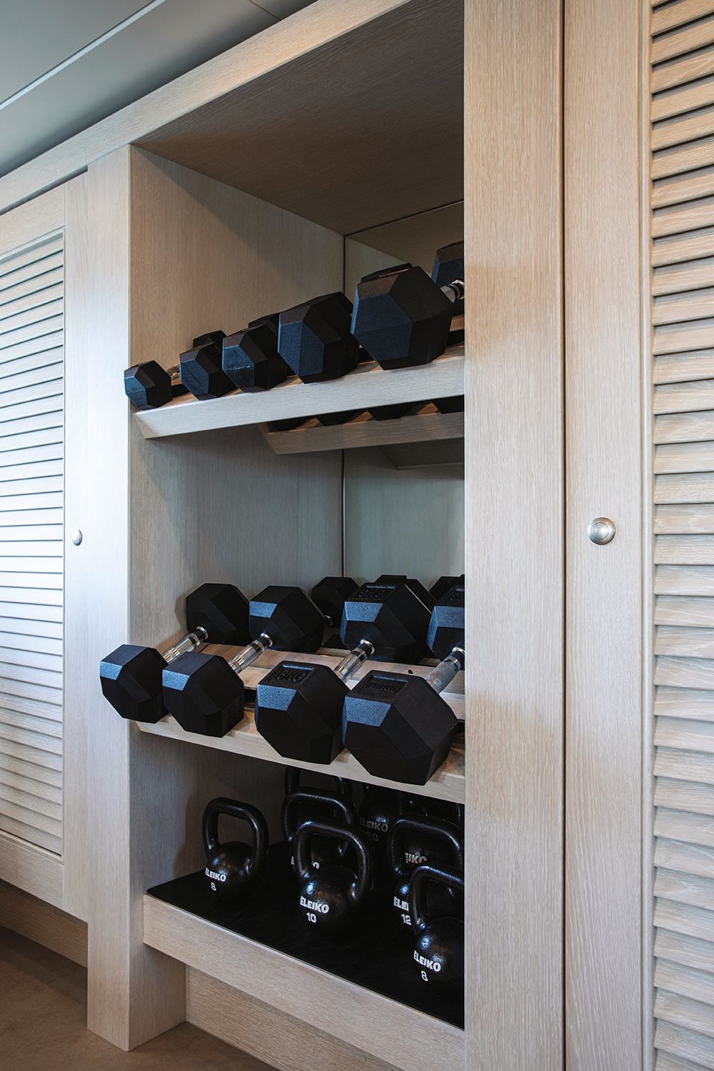 Close-up of black and chrome dumbells in different sizes