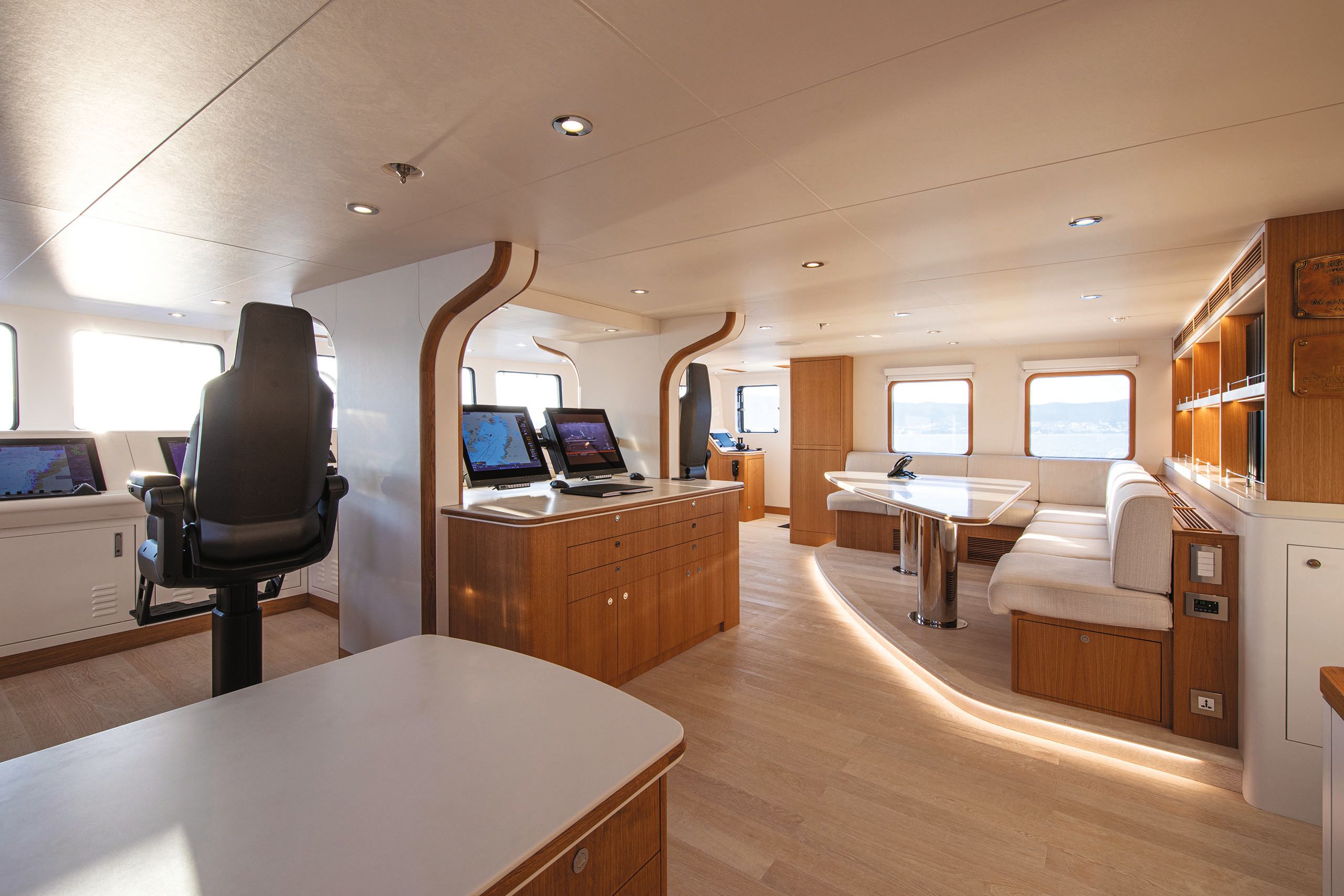 Bridge area showing large black leather chair facing multiple screens