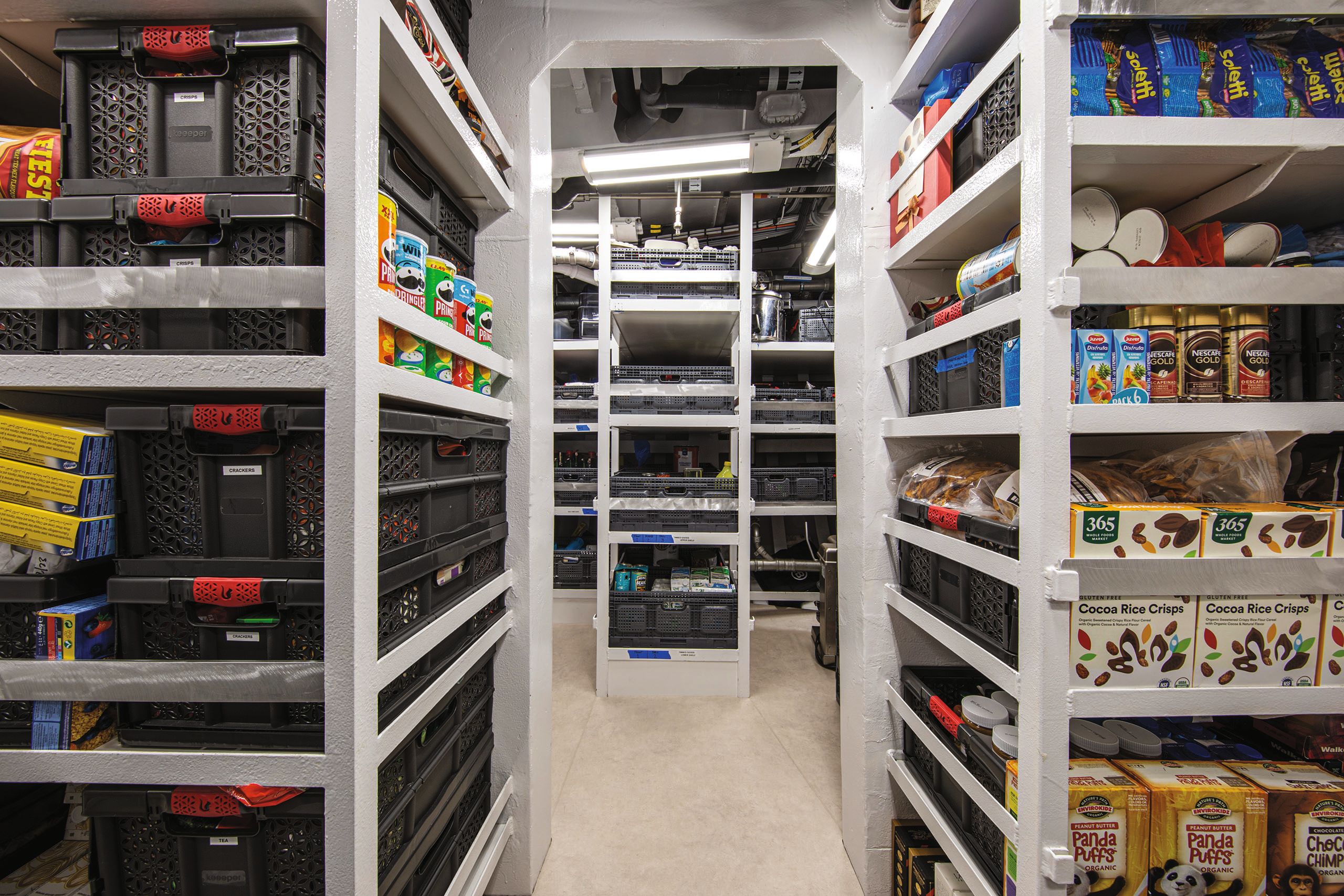 Large storage room with metal shelves full of food