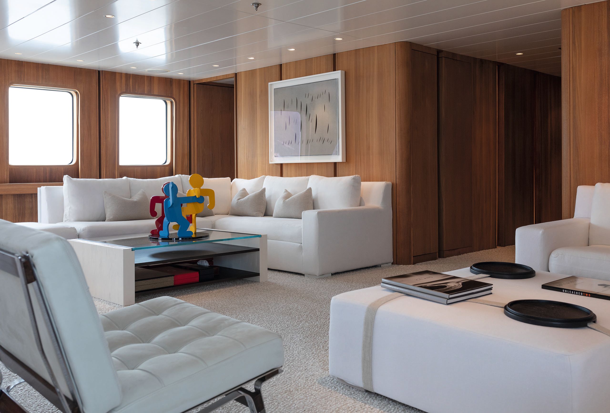 Before the refit the room had dark wood walls and white sofa/chairs