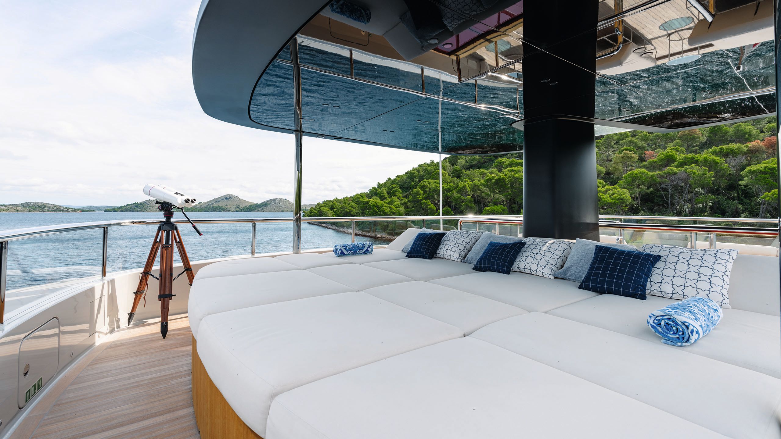 Large white sunpads with a telescope in the background facing the ocean