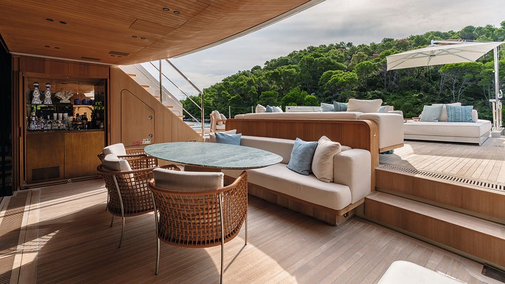 An oval marble dining table with chairs around it