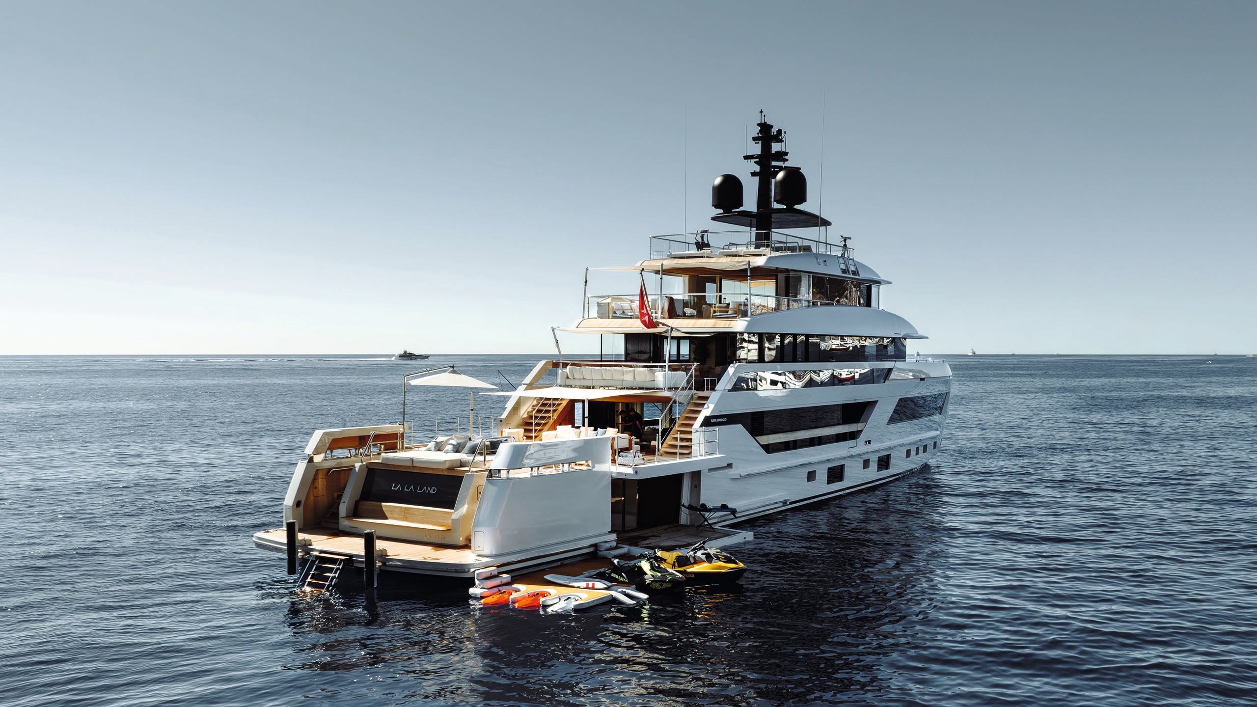 Side view of La La Land on the water with water toys and extended decks