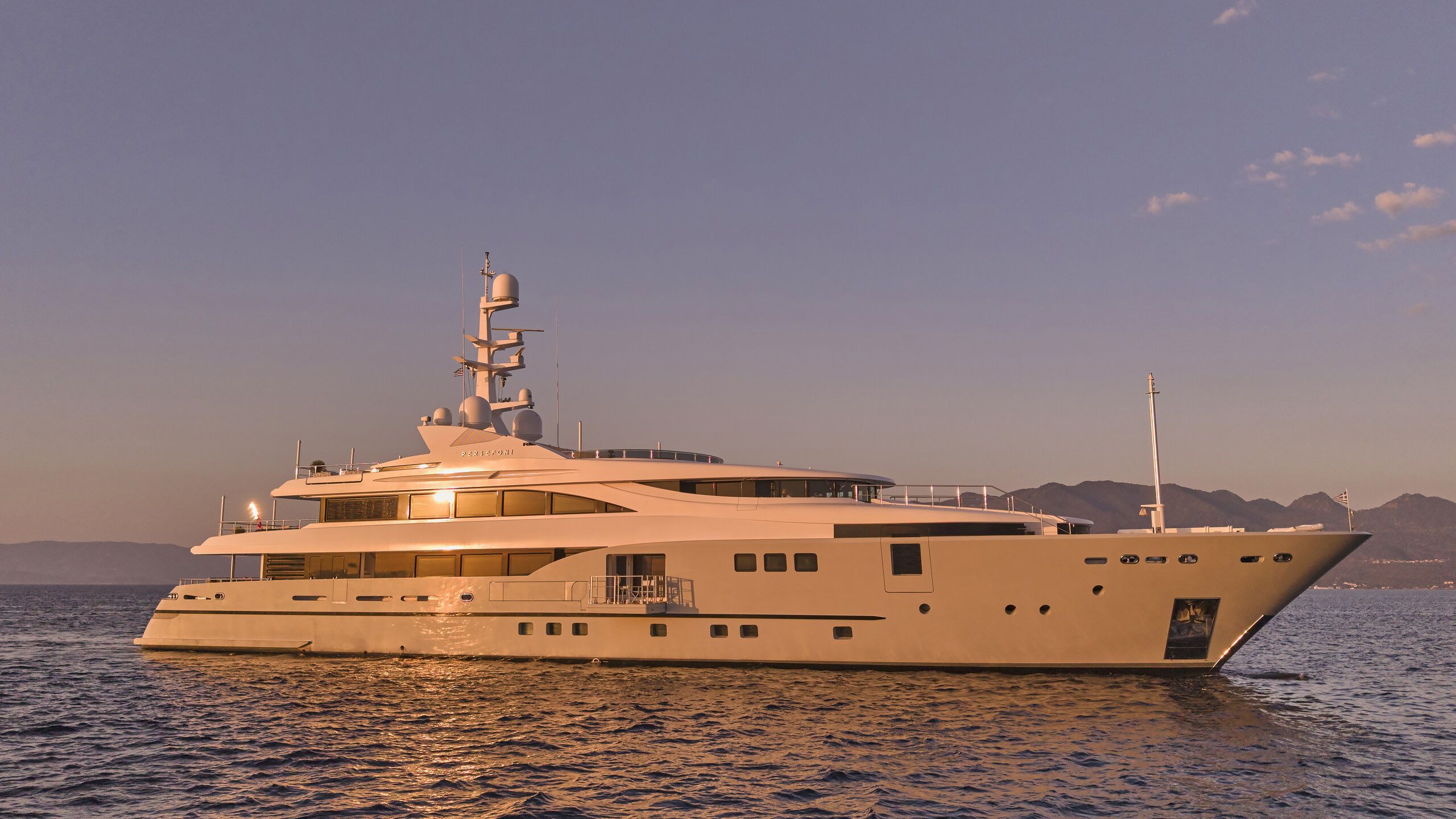 Persefoni I at sunset, hull glowing orange
