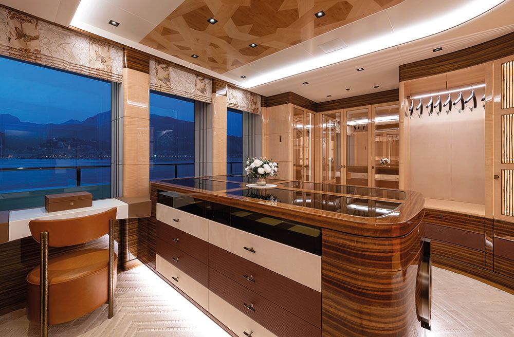 Wardrobe area with chest of drawers, table and chair