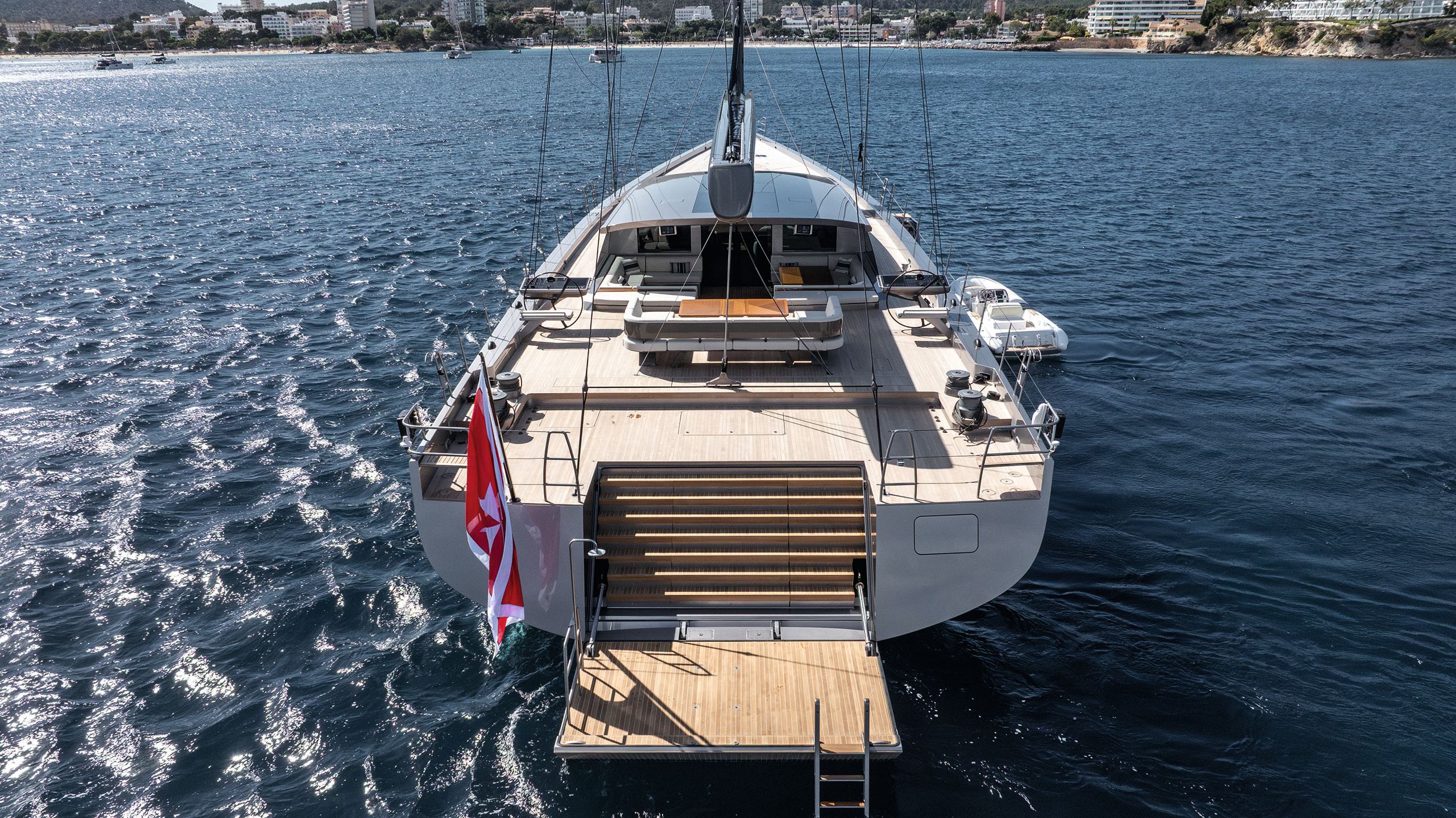 A view from behind of the transom hatch which is open with ladder leading to the water