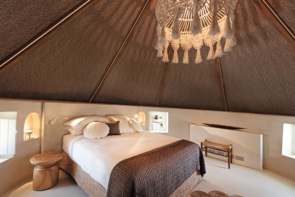 A hotel bedroom done in brows and creams