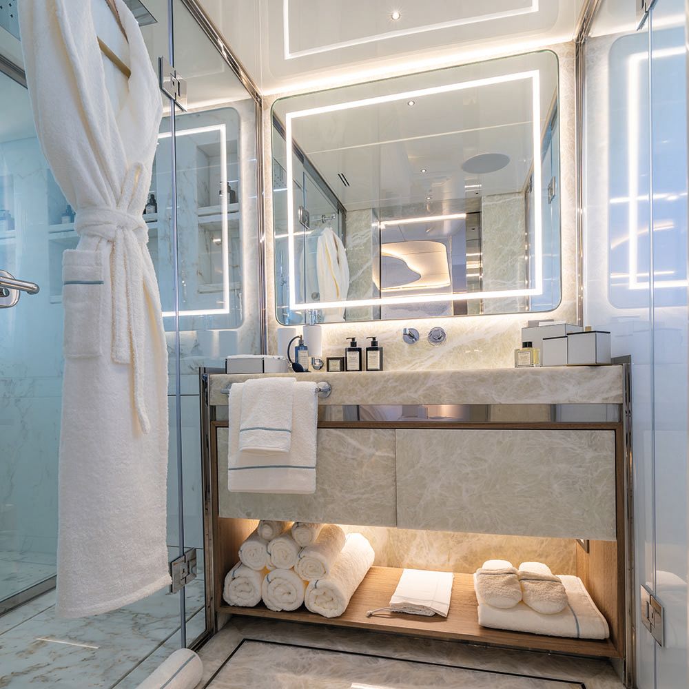 Inside one of the bathrooms; the colour scheme is neutral and features grey/white marbelling