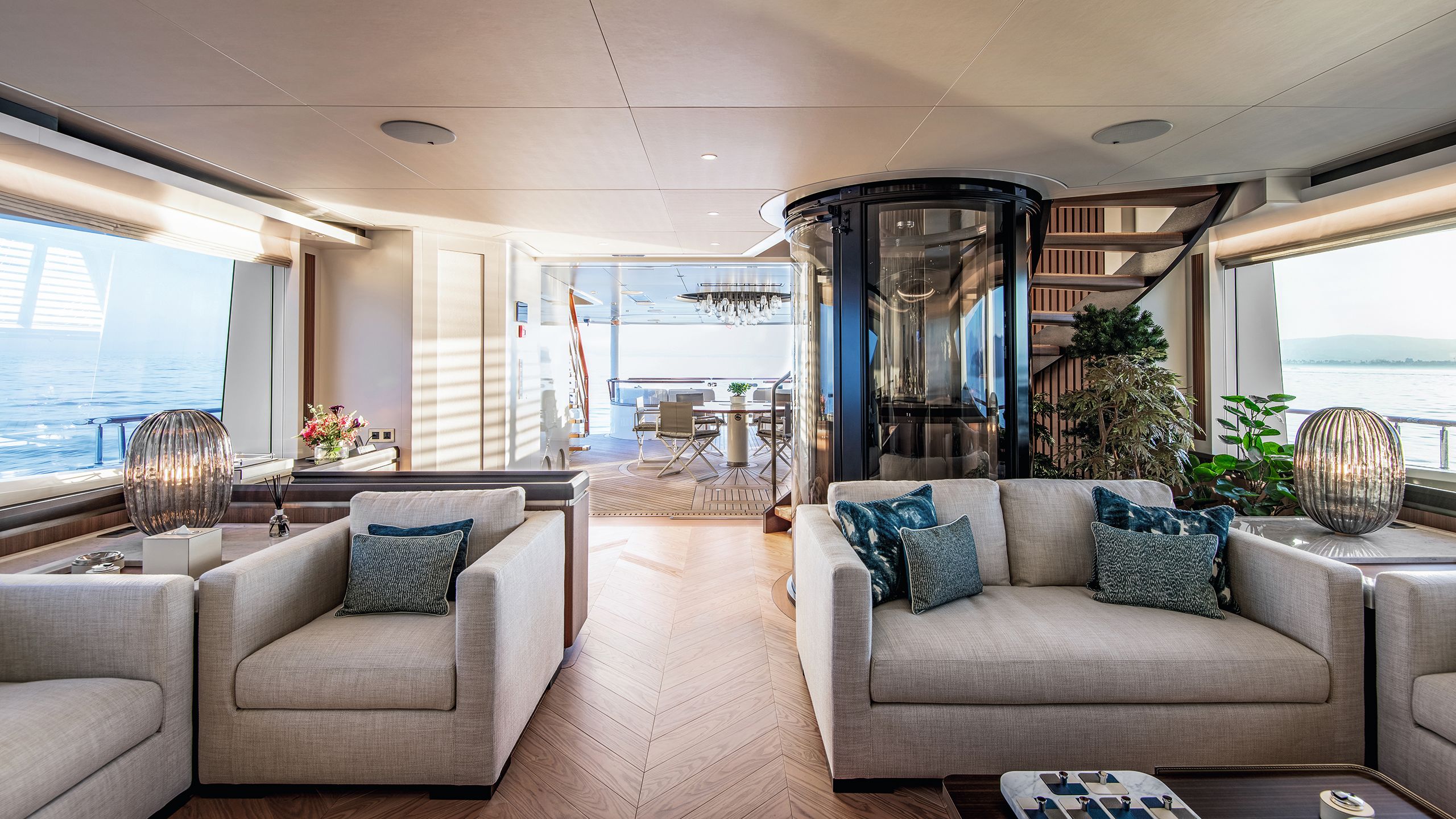 Main saloon area featuring soft seating in a neutral colour fabric with blue cushions