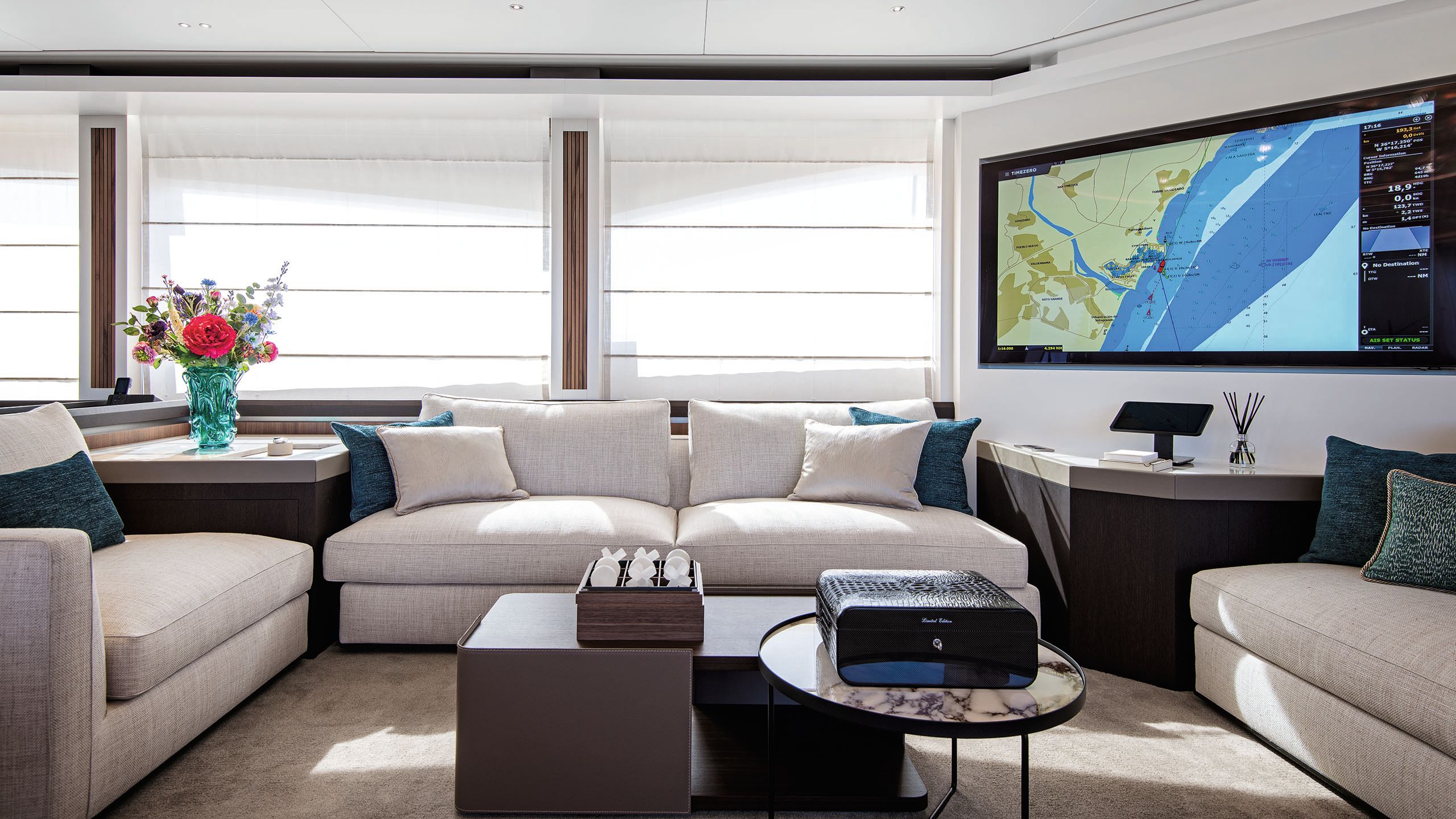 Alternative view of the white sofa area and a large, wall-mounted TV