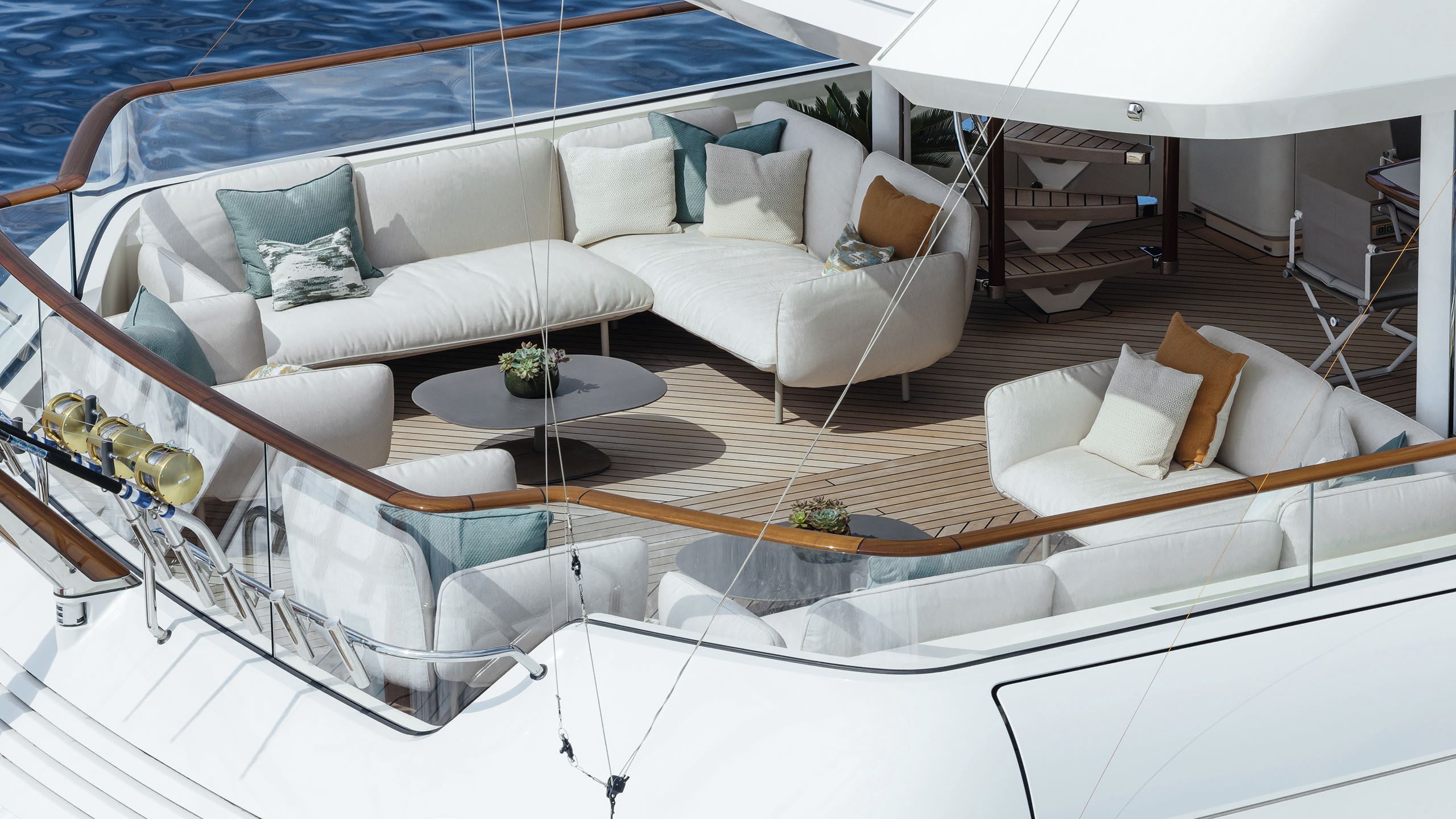 Mezzanine-style area with white sofas, oval grey coffee table and blue and orange cushions